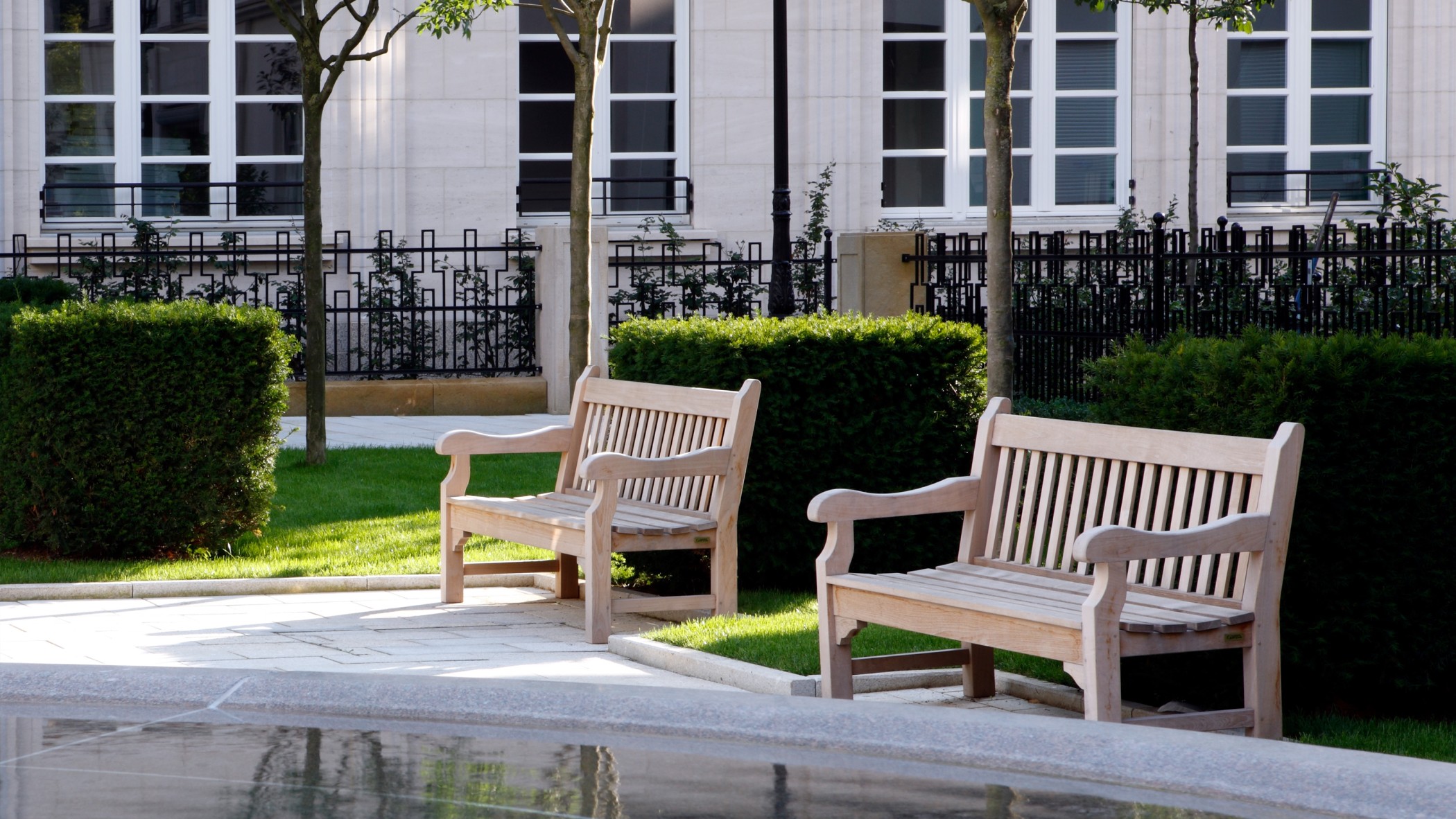 Innenhof mit grüner Parkanlage und Springbrunnen im exklusiven Wohnquartier Lenbach Gärten München